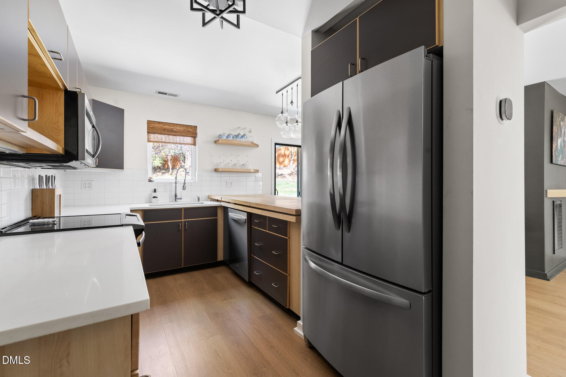 5208 Saddle Court Raleigh, NC 27609 - Photo 10 of 43 a kitchen with stainless steel appliances a refrigerator sink and microwave
