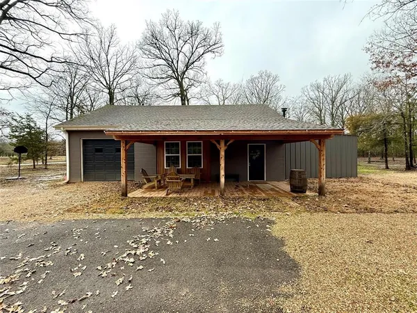 a front view of a house with a tree in a yard