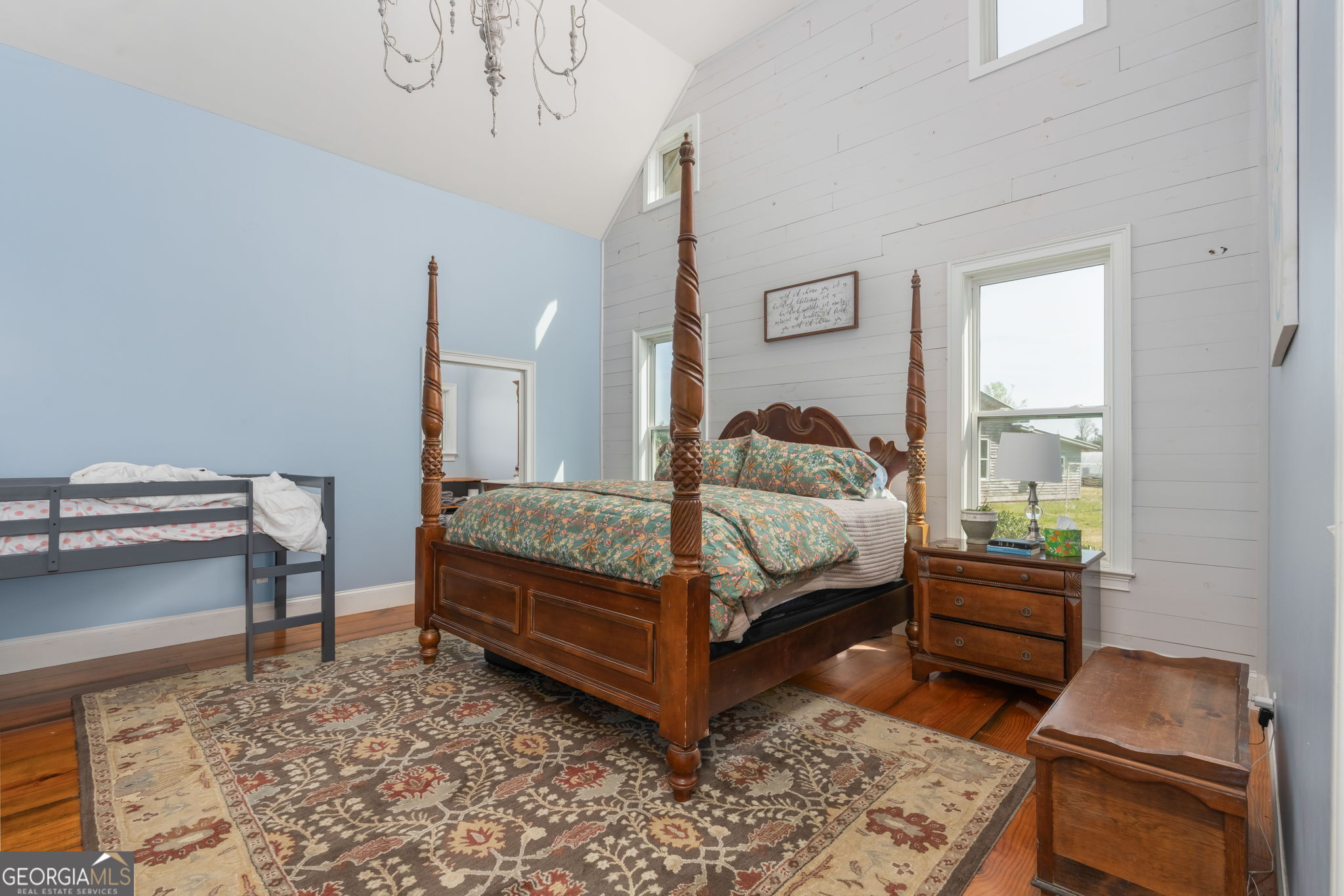 1725 Watermelon Road Tennille, GA 31089 - Photo 15 of 55 a bedroom with a bed and a dresser with wooden floor