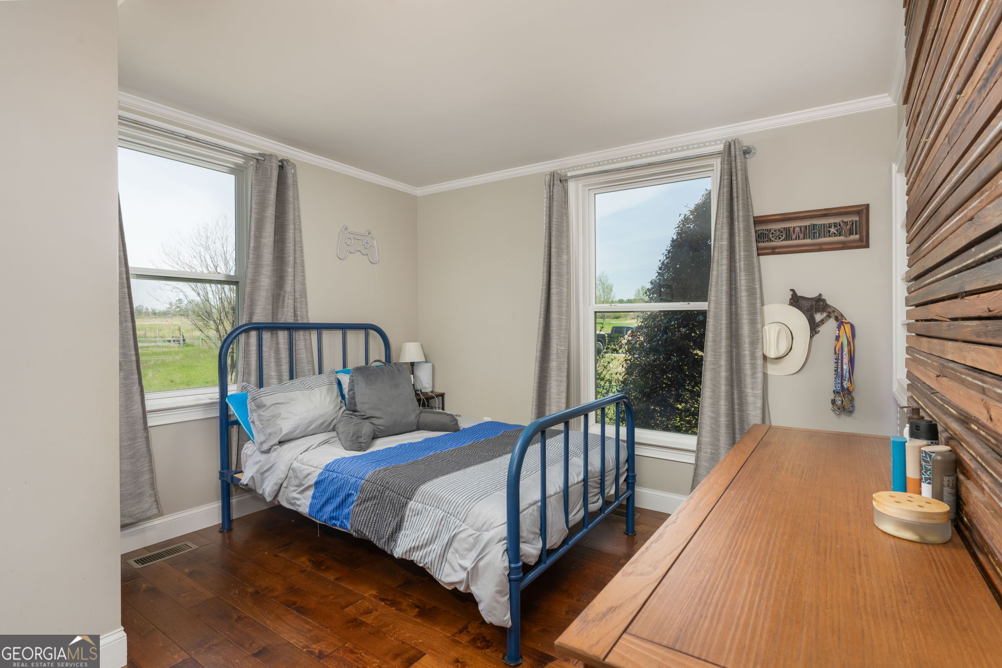 1725 Watermelon Road Tennille, GA 31089 - Photo 23 of 55 a bed sitting in a bedroom next to a window