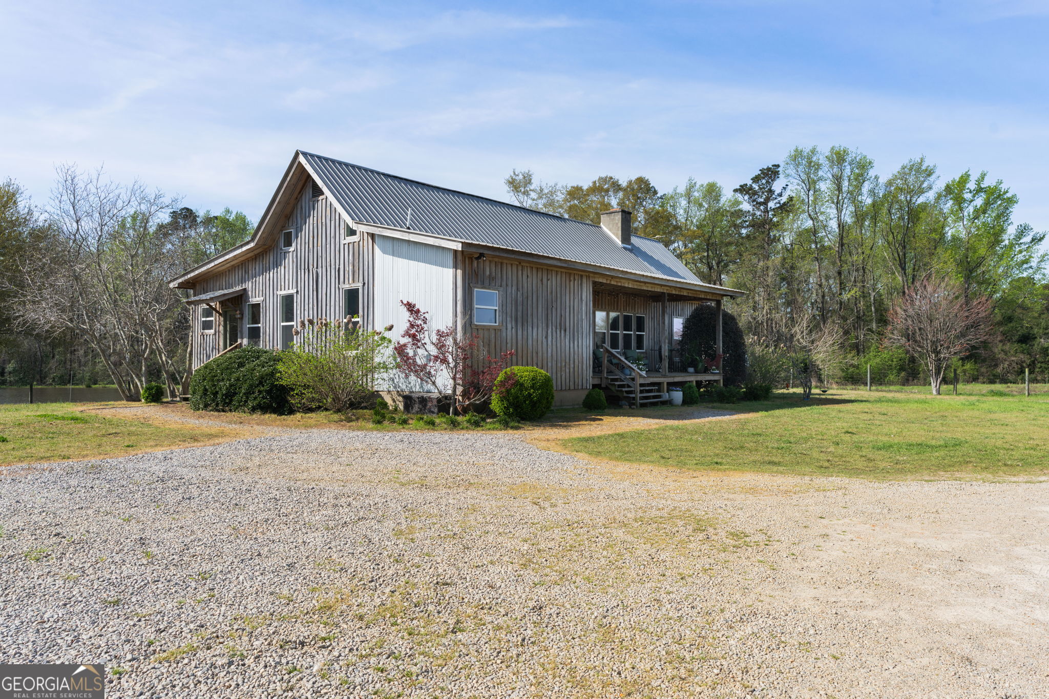 1725 Watermelon Road Tennille, GA 31089 - Photo 32 of 55 a front view of house with yard and trees in the background