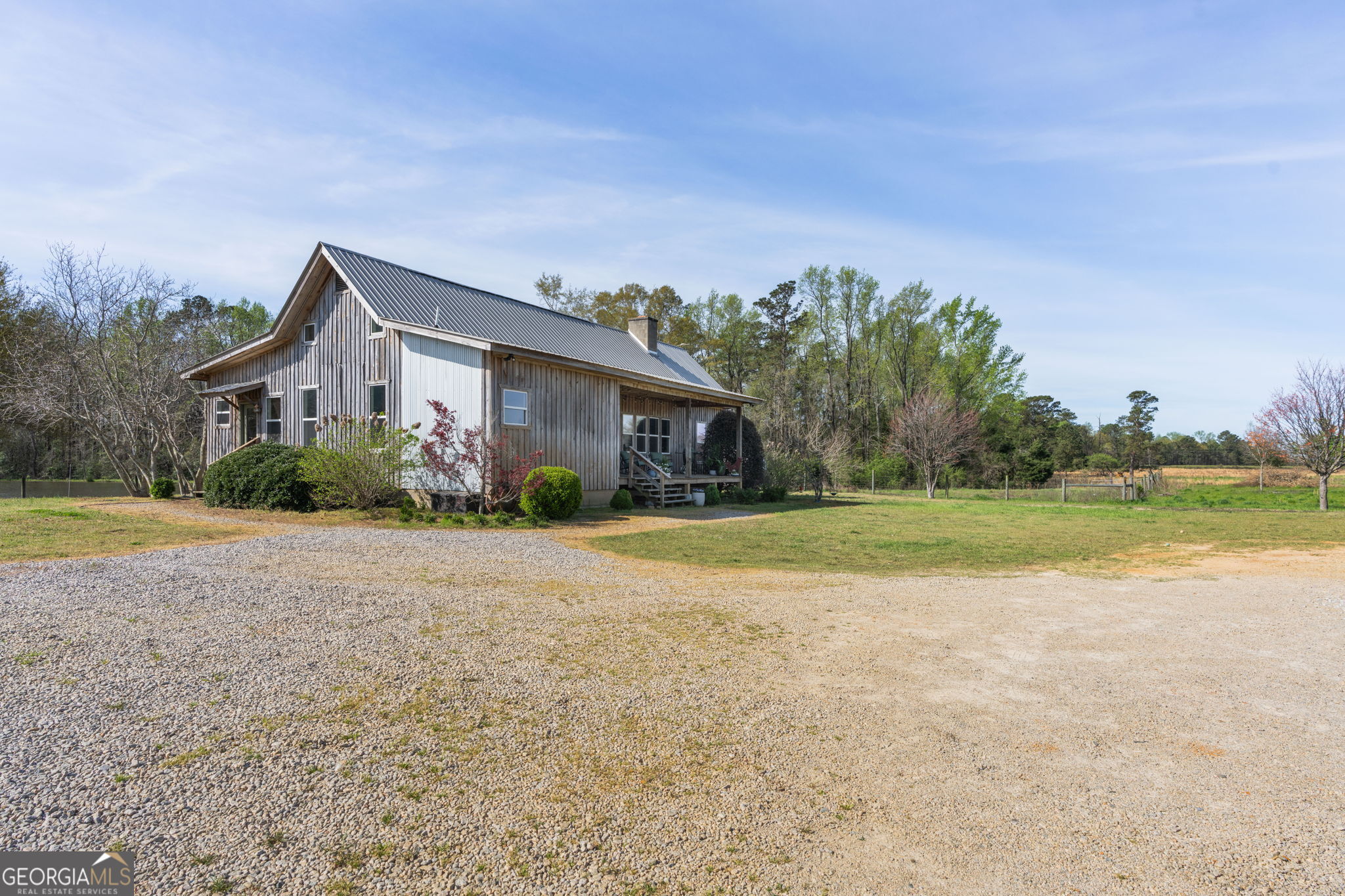 1725 Watermelon Road Tennille, GA 31089 - Photo 33 of 55 a front view of a house with a yard and palm trees