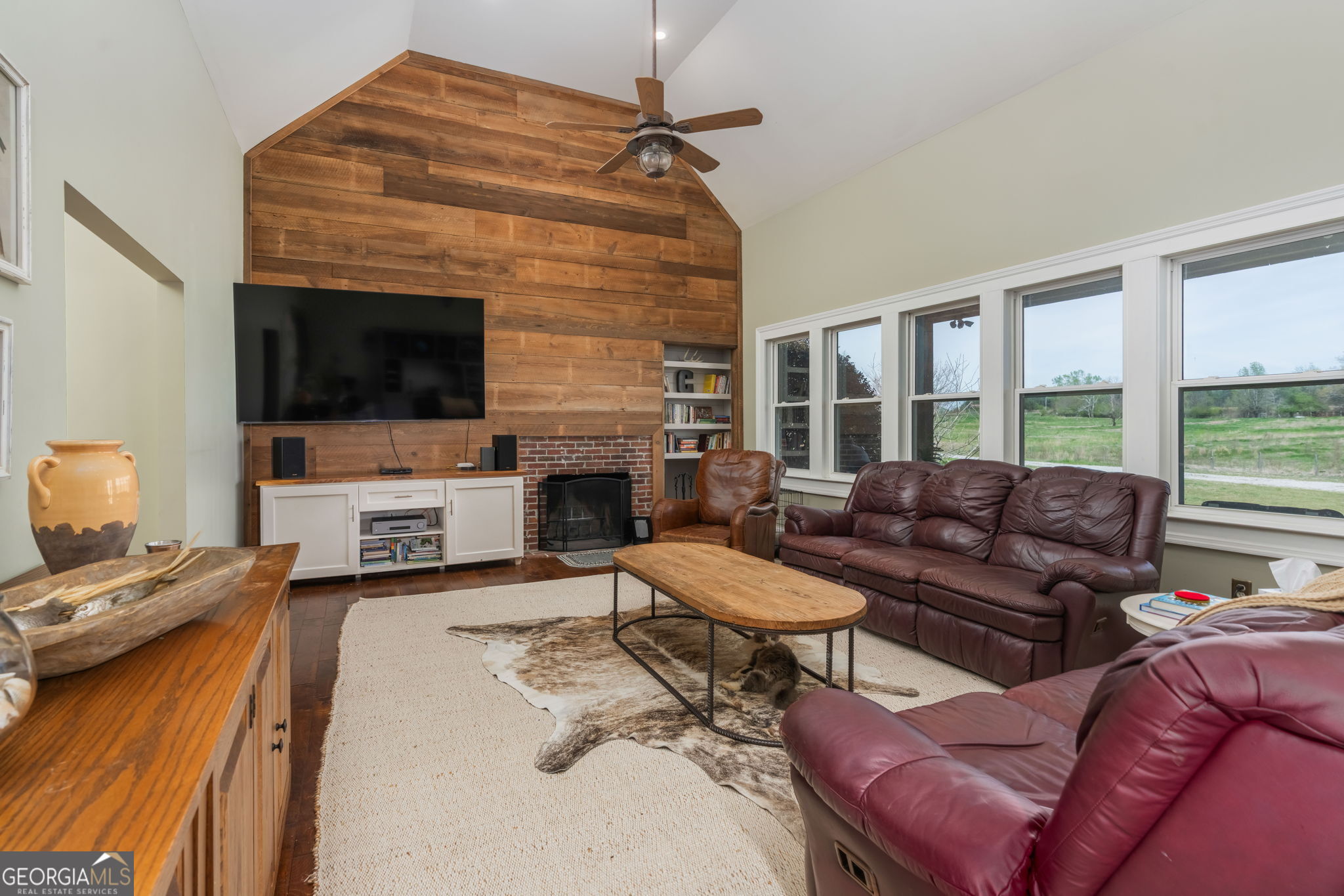 1725 Watermelon Road Tennille, GA 31089 - Photo 4 of 55 a living room with furniture a fireplace and a flat screen tv