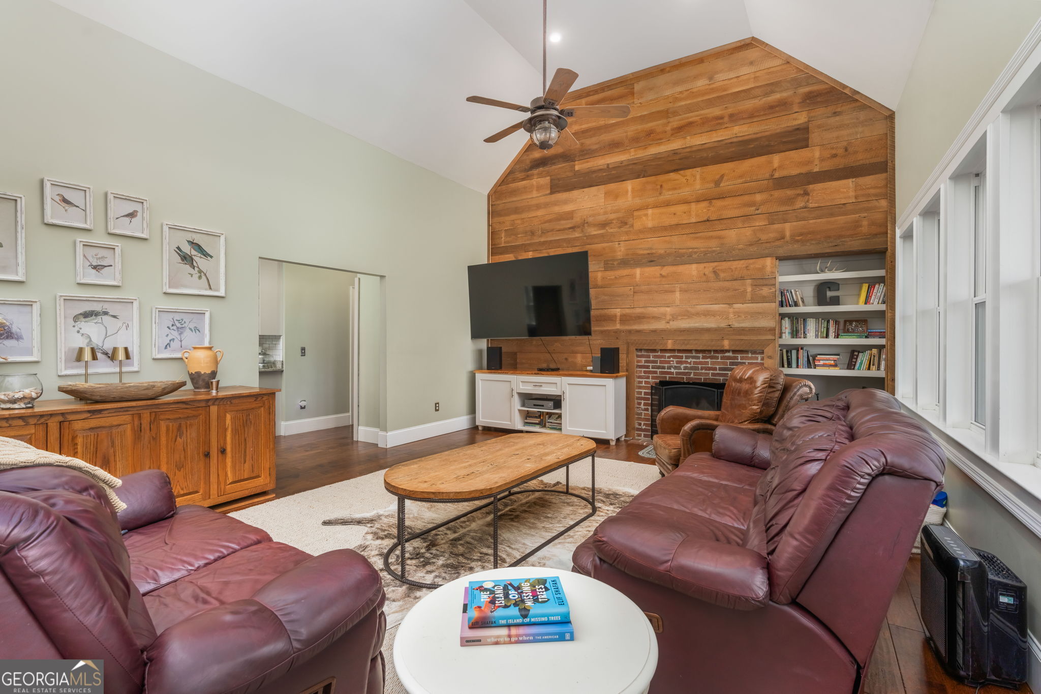 1725 Watermelon Road Tennille, GA 31089 - Photo 5 of 55 a living room with furniture a flat screen tv and a fireplace