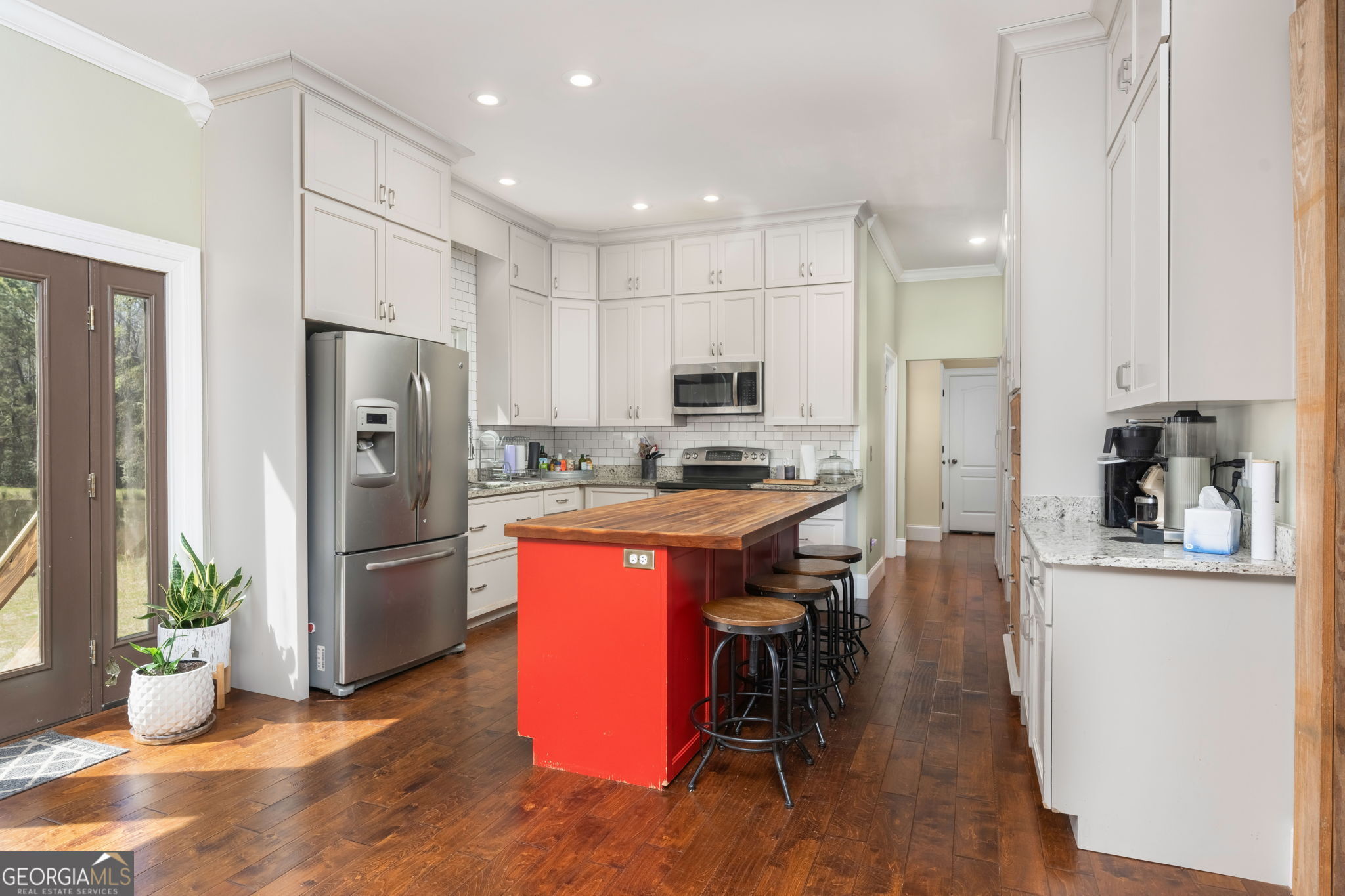 1725 Watermelon Road Tennille, GA 31089 - Photo 8 of 55 a kitchen with a refrigerator a sink and a dining table