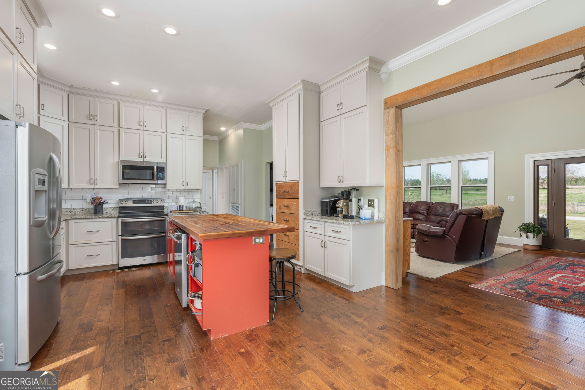 1725 Watermelon Road Tennille, GA 31089 - Photo 9 of 55 a large kitchen with cabinets wooden floor and stainless steel appliances