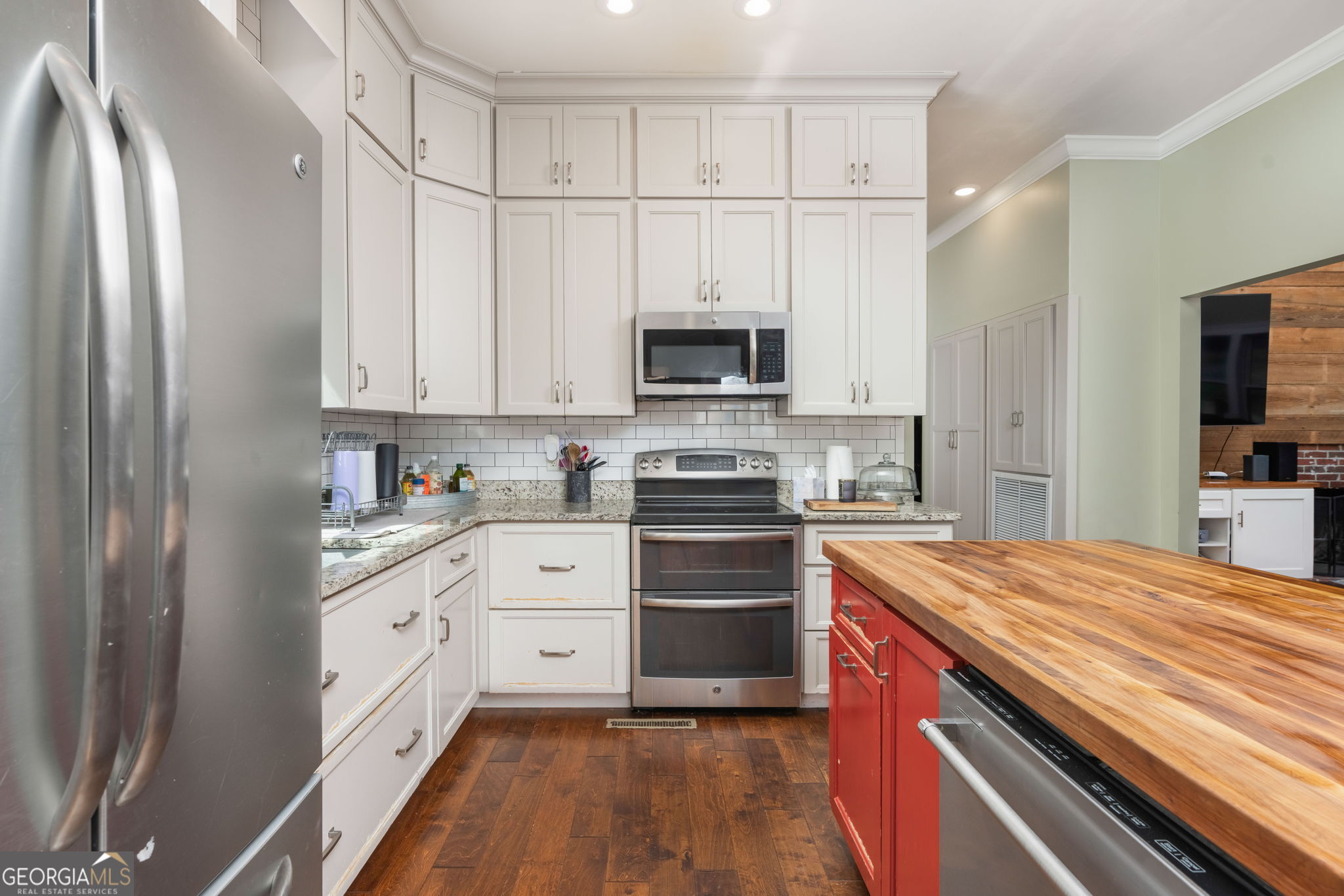 1725 Watermelon Road Tennille, GA 31089 - Photo 10 of 55 a kitchen with stainless steel appliances a stove cabinets and a refrigerator
