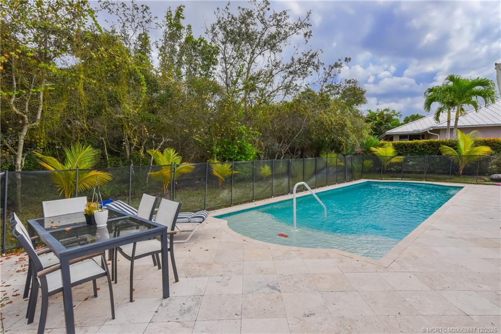 5374 Southeast Running Oak Circle Stuart, FL 34997 - Photo 11 of 38 a backyard of a house with table and chairs