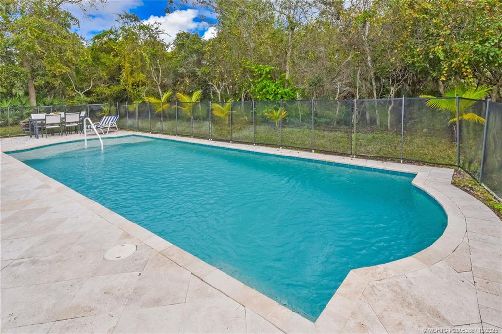 5374 Southeast Running Oak Circle Stuart, FL 34997 - Photo 13 of 38 a view of a swimming pool with a yard
