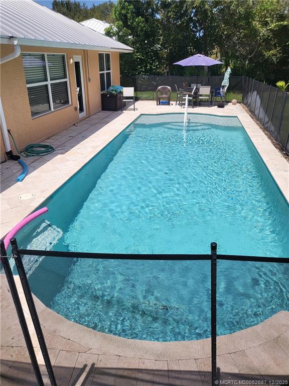 5374 Southeast Running Oak Circle Stuart, FL 34997 - Photo 14 of 38 a view of a house with backyard swimming pool and sitting area