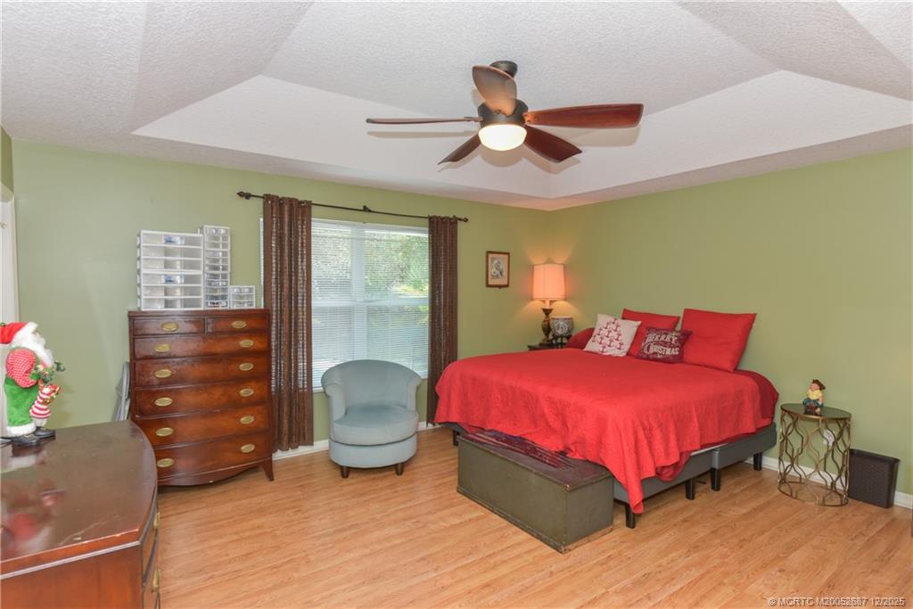 5374 Southeast Running Oak Circle Stuart, FL 34997 - Photo 17 of 38 a bedroom with a bed and a dresser