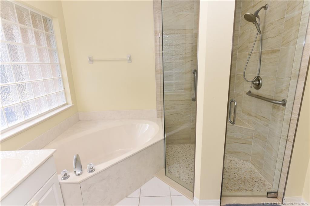 5374 Southeast Running Oak Circle Stuart, FL 34997 - Photo 19 of 38 a bathroom with a bathtub and shower