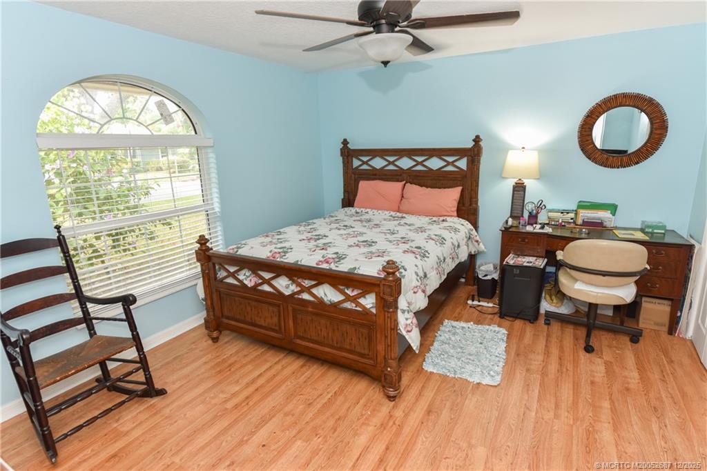 5374 Southeast Running Oak Circle Stuart, FL 34997 - Photo 21 of 38 a bedroom with a bed and a window