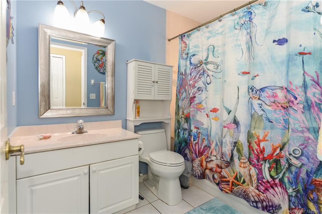 5374 Southeast Running Oak Circle Stuart, FL 34997 - Photo 23 of 38 a bathroom with a sink and a mirror with toilet