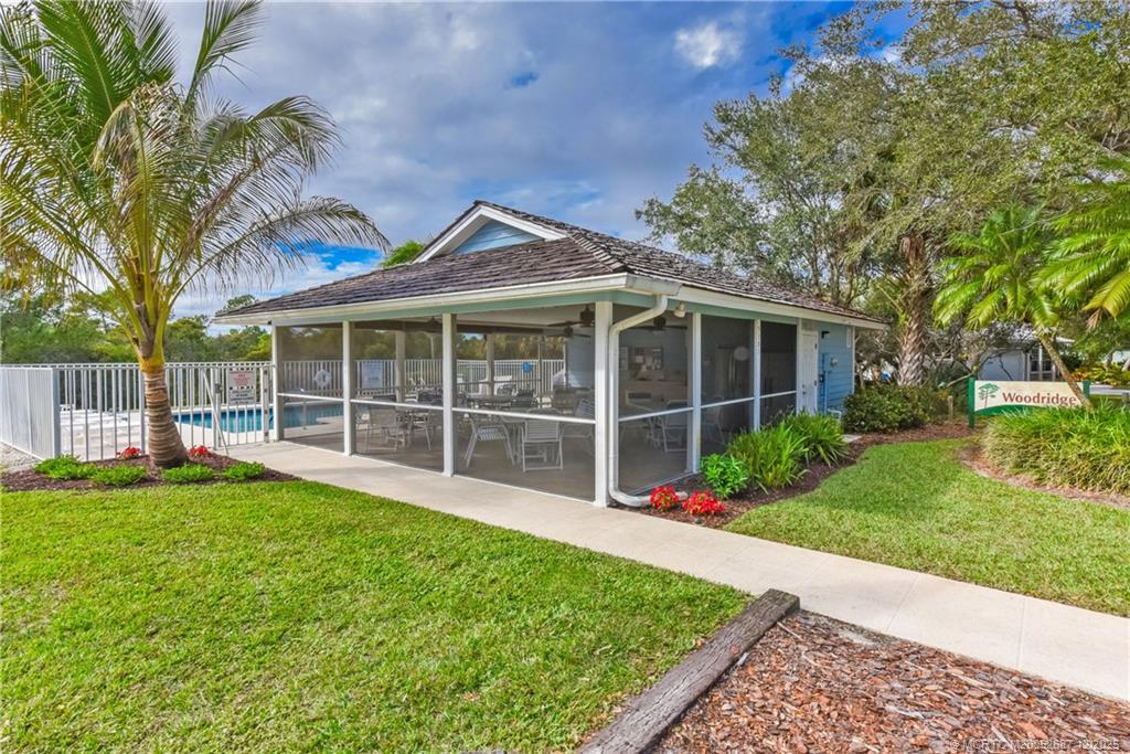 5374 Southeast Running Oak Circle Stuart, FL 34997 - Photo 32 of 38 a view of a house with a garden