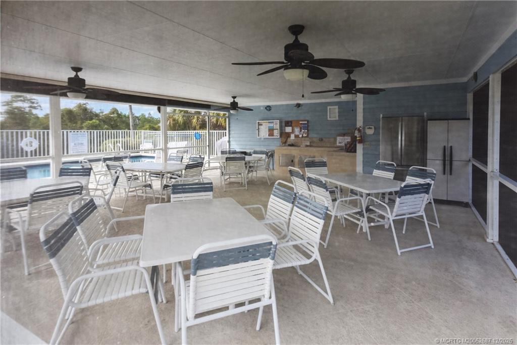 5374 Southeast Running Oak Circle Stuart, FL 34997 - Photo 33 of 38 a dining room with stainless steel appliances granite countertop a table and chairs