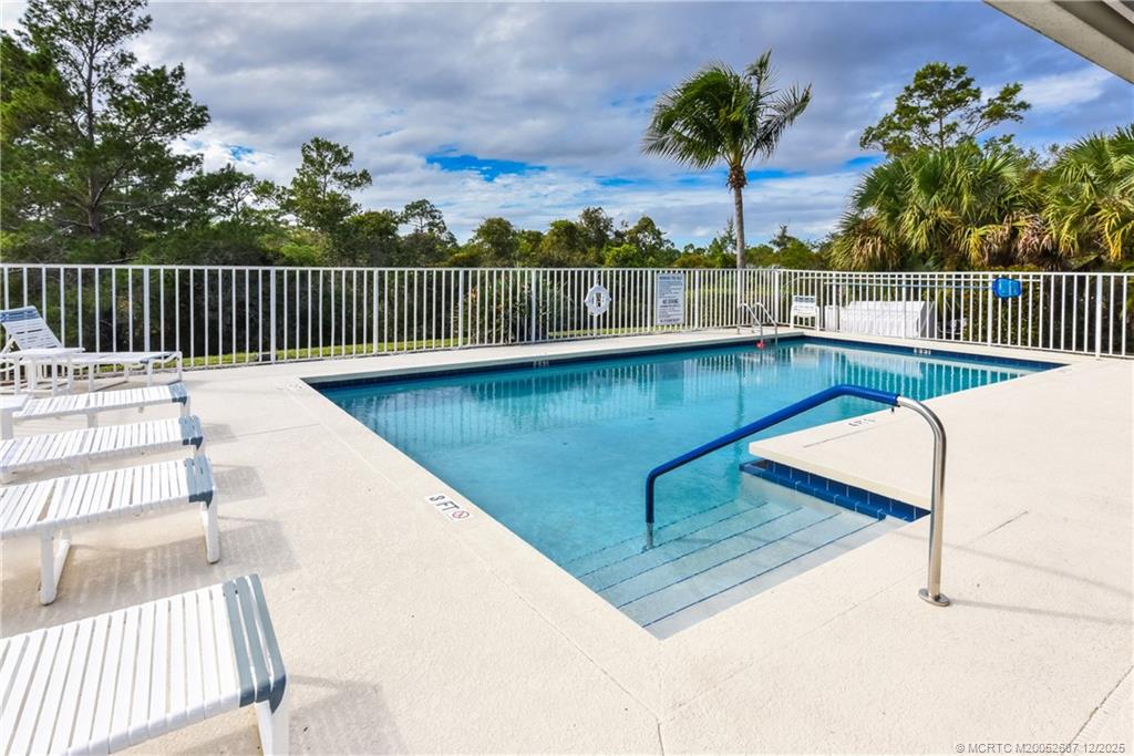 5374 Southeast Running Oak Circle Stuart, FL 34997 - Photo 34 of 38 a view of a swimming pool with a lounge chairs