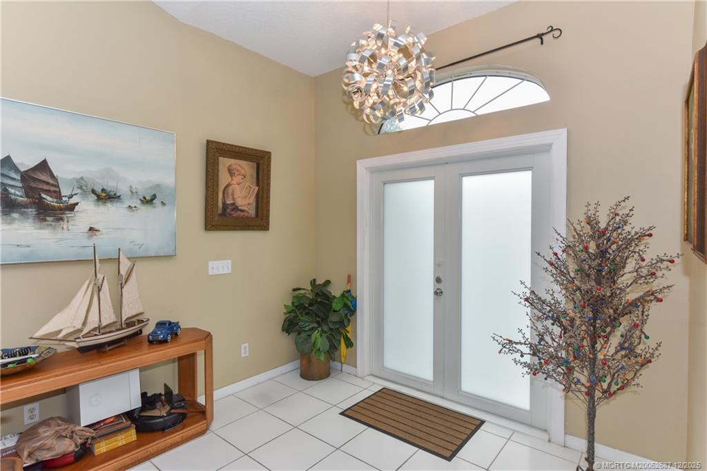 5374 Southeast Running Oak Circle Stuart, FL 34997 - Photo 4 of 38 a view of a room with a potted plant and wooden floor