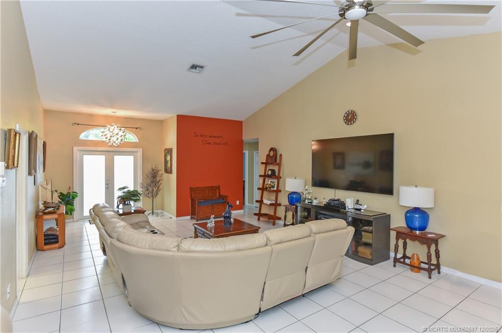 5374 Southeast Running Oak Circle Stuart, FL 34997 - Photo 5 of 38 a living room with furniture and a flat screen tv