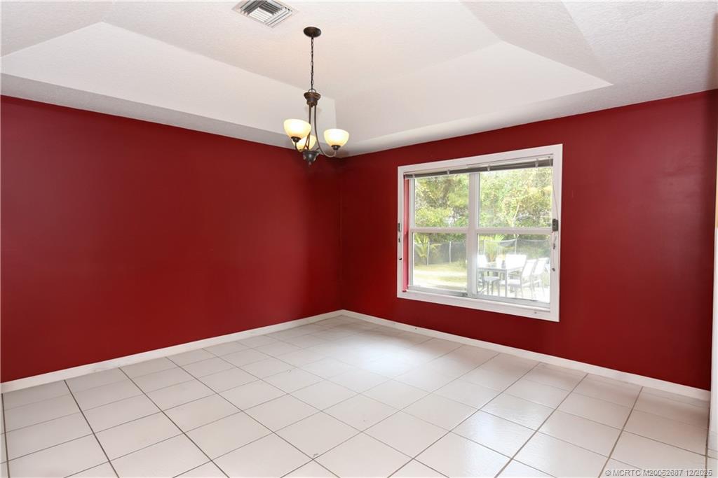 5374 Southeast Running Oak Circle Stuart, FL 34997 - Photo 8 of 38 a view of an empty room with a window