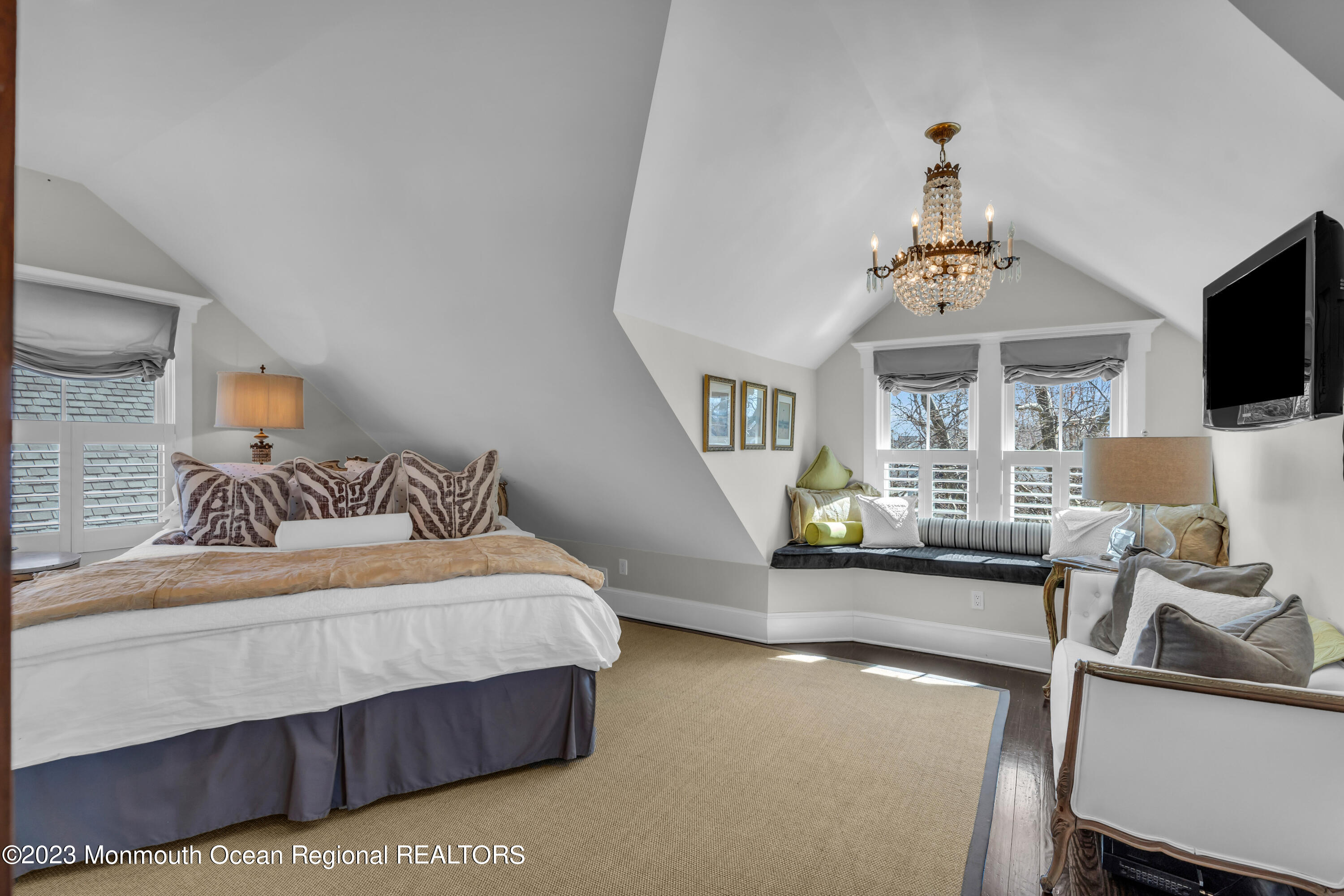 310 Worthington Avenue Spring Lake, NJ 07762 - Photo 30 of 53 a bedroom with a bed and a chandelier