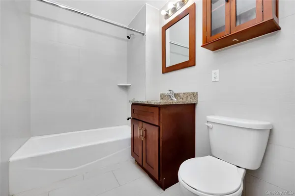 a white toilet sitting next to a bath tub