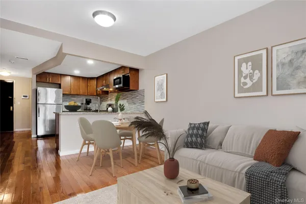 a living room with furniture and kitchen view
