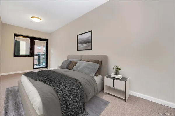 a large bed sitting in a bedroom next to a window with a dresser