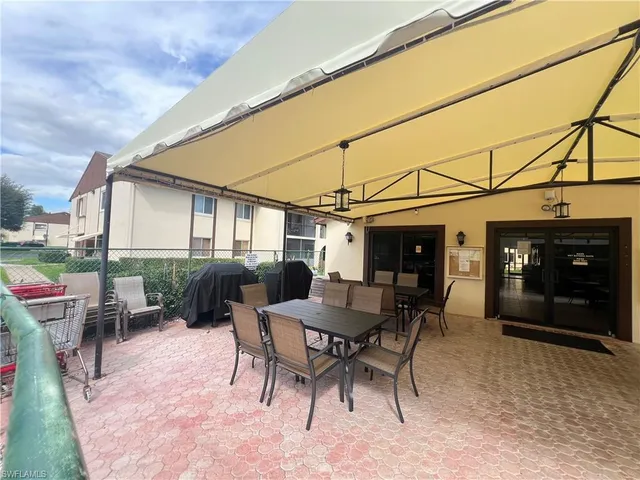 a view of a patio with a table and chairs