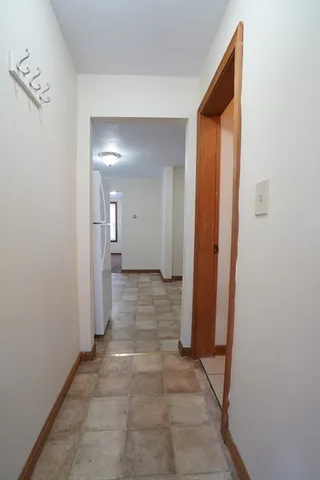 a view of a hallway with wooden shelves
