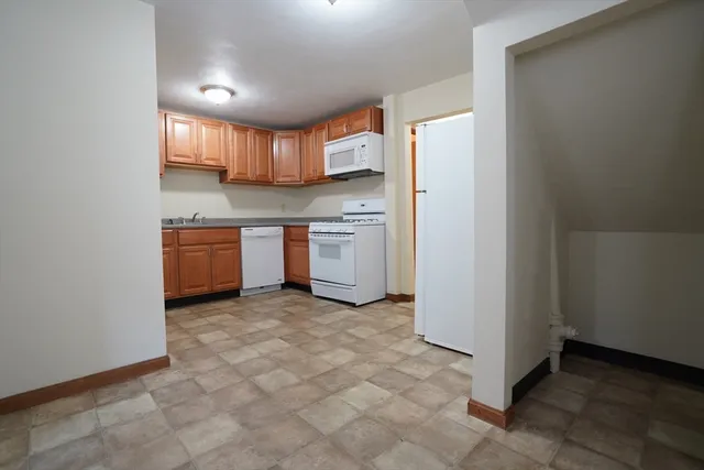 a kitchen with stainless steel appliances a refrigerator and a stove top oven