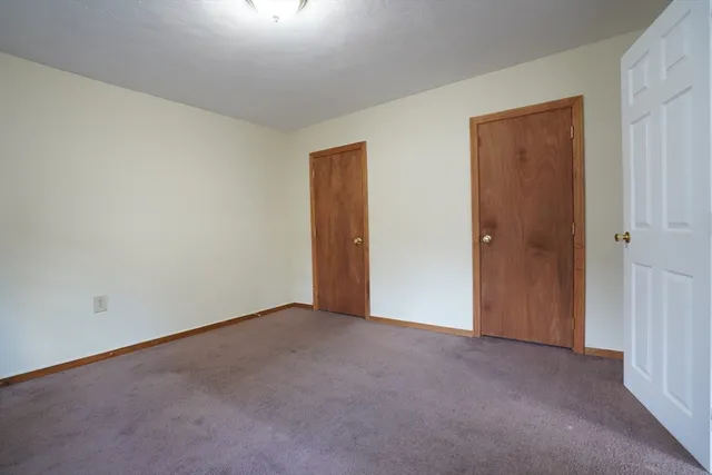 a view of an empty room and closet area