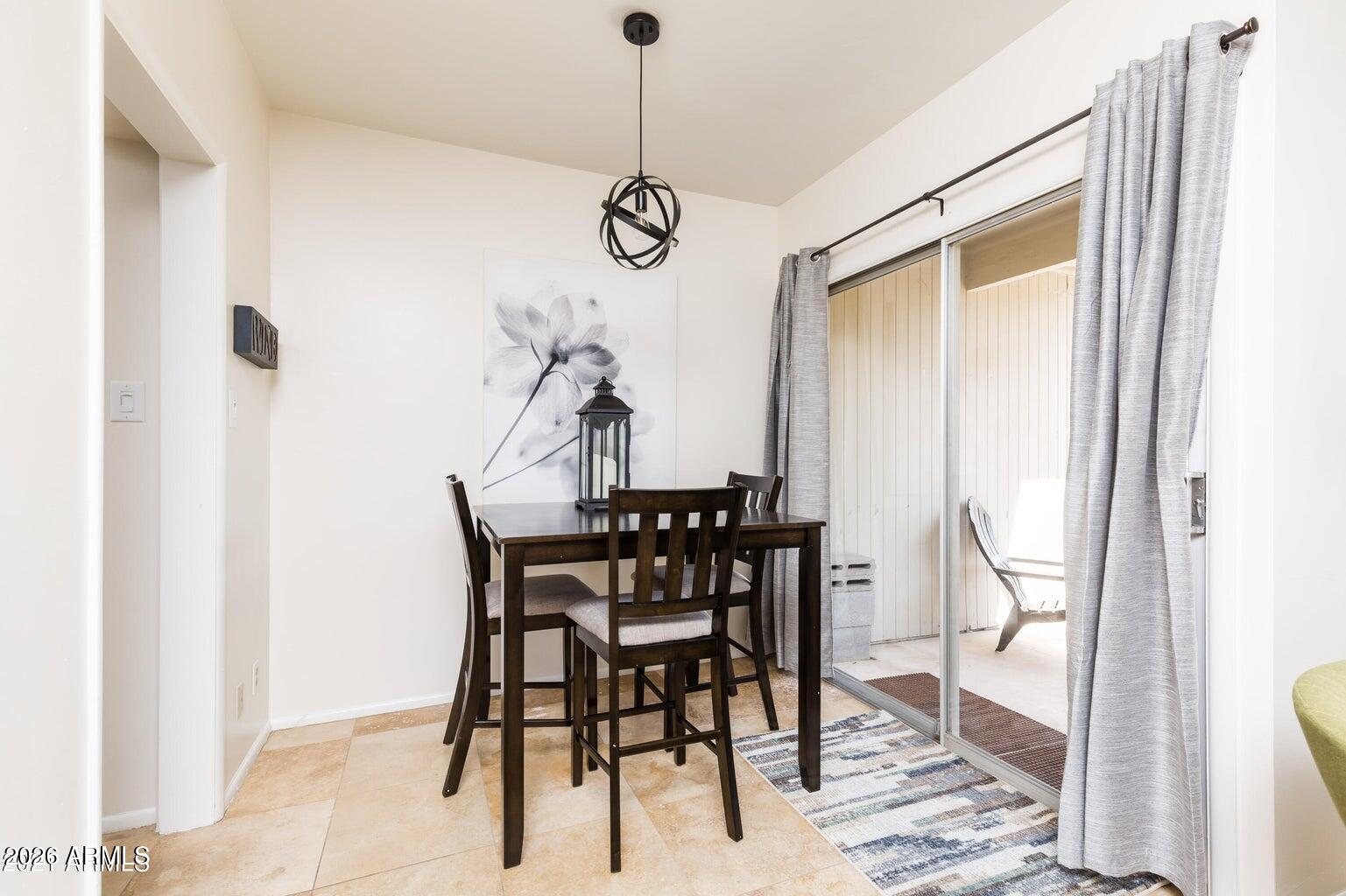 3242 East Camelback Road, Unit 104 Phoenix, AZ 85018 - Photo 11 of 19 a view of a dining room with furniture and wooden floor