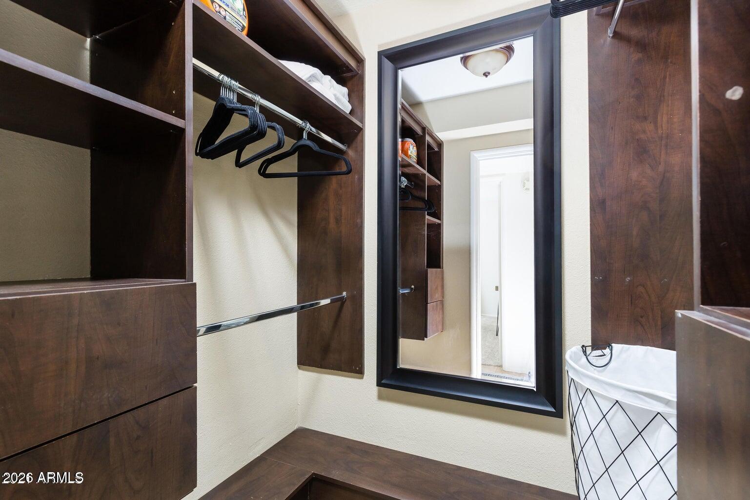 3242 East Camelback Road, Unit 104 Phoenix, AZ 85018 - Photo 13 of 19 a view of walk in closet with clothes