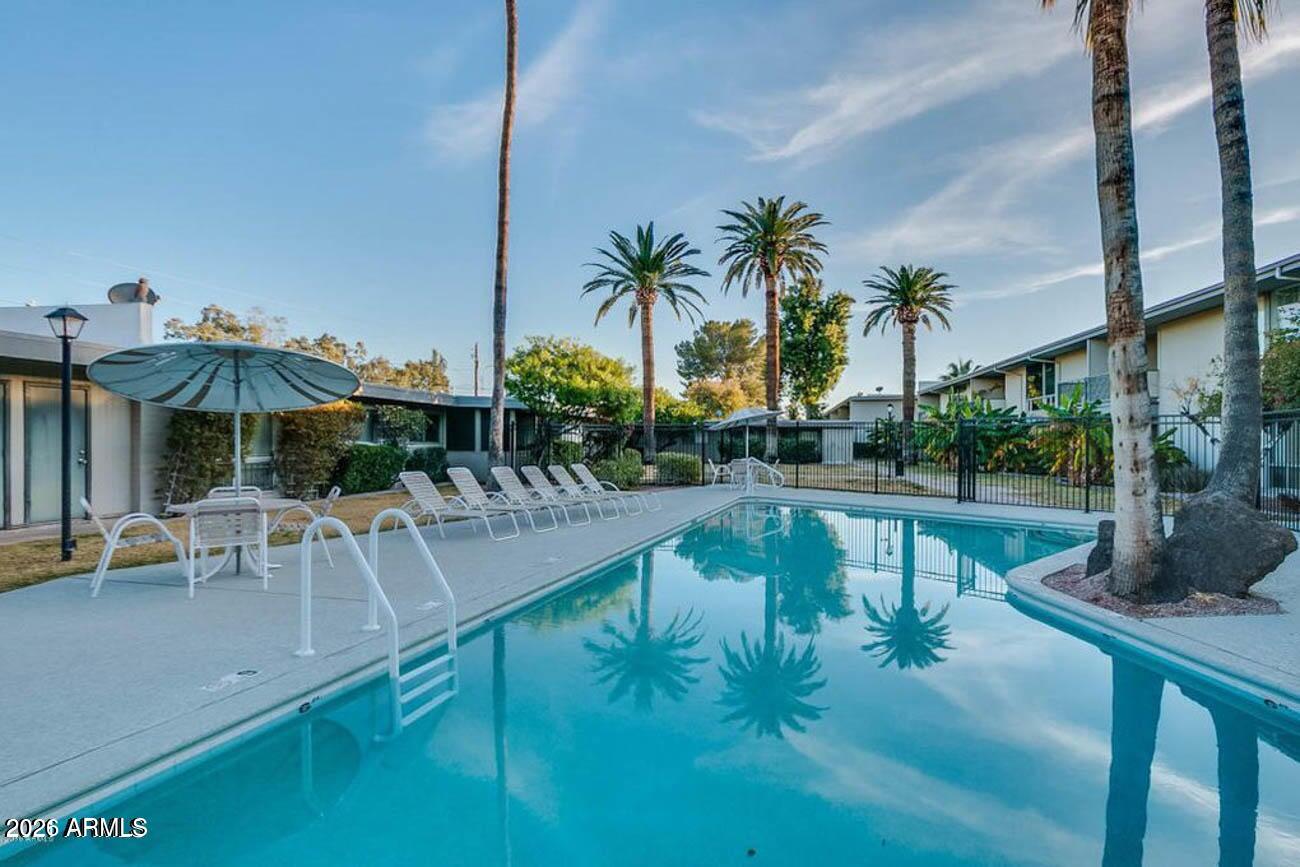 3242 East Camelback Road, Unit 104 Phoenix, AZ 85018 - Photo 15 of 19 a view of swimming pool with outdoor seating