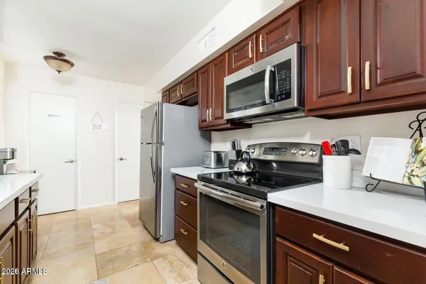 a kitchen with stainless steel appliances granite countertop a stove microwave and refrigerator