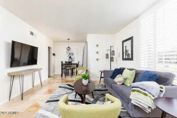 a living room with furniture and a flat screen tv