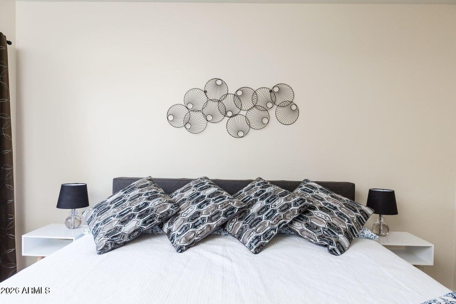 3242 East Camelback Road, Unit 104 Phoenix, AZ 85018 - Photo 7 of 19 a bedroom with a bed and ceiling fan