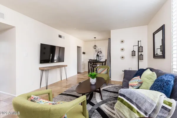 a living room with furniture and a flat screen tv