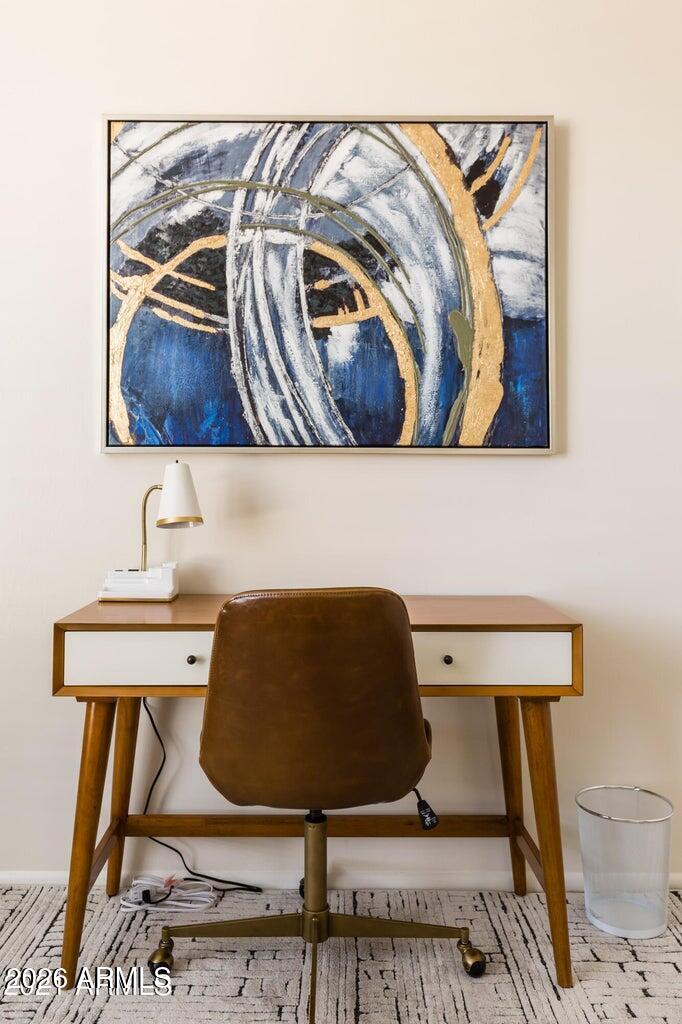 3242 East Camelback Road, Unit 104 Phoenix, AZ 85018 - Photo 10 of 19 a living room with a couch and a table