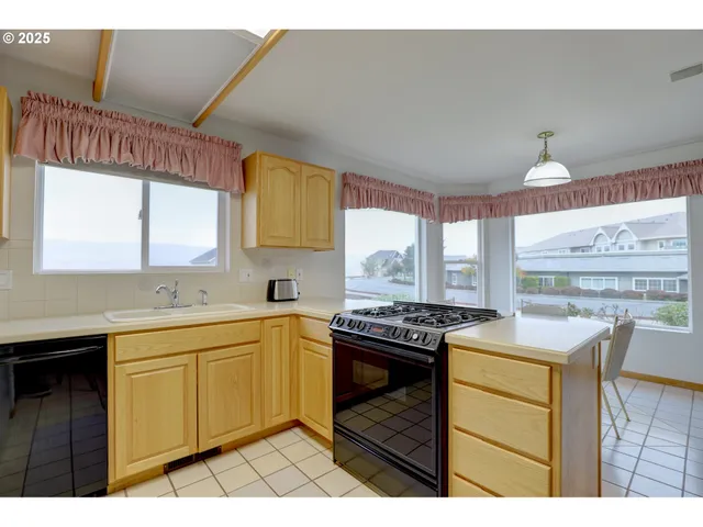 a kitchen with a stove a sink and a refrigerator