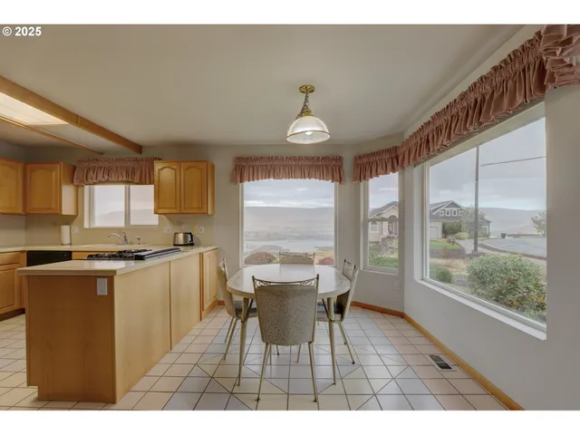 a dining room with furniture a chandelier and wooden floor