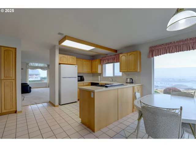 a open kitchen with cabinets and a stove