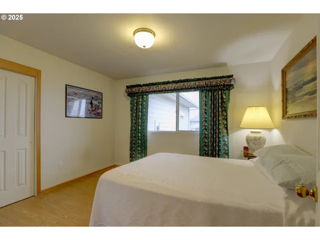 a bedroom with a bed and a night stand