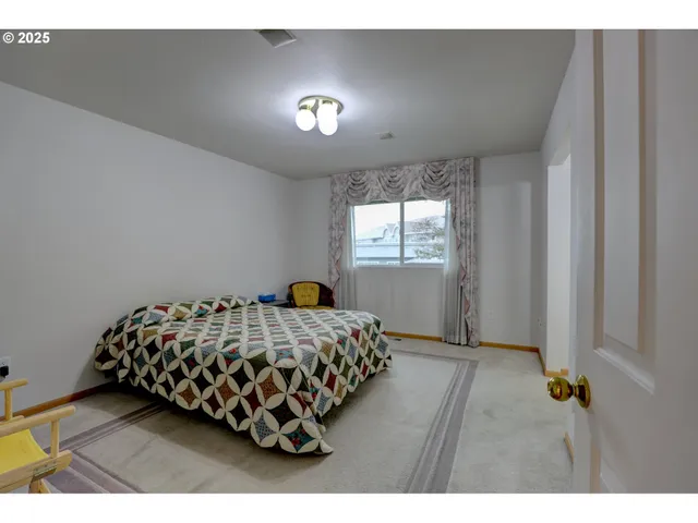 a bedroom with bed and window