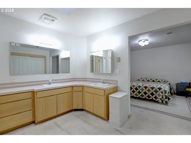 a en suite bathroom with a double vanity sink and a mirror