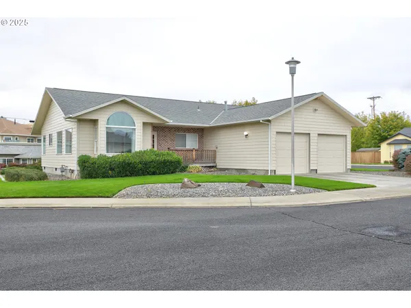 a front view of a house with a garden and garage