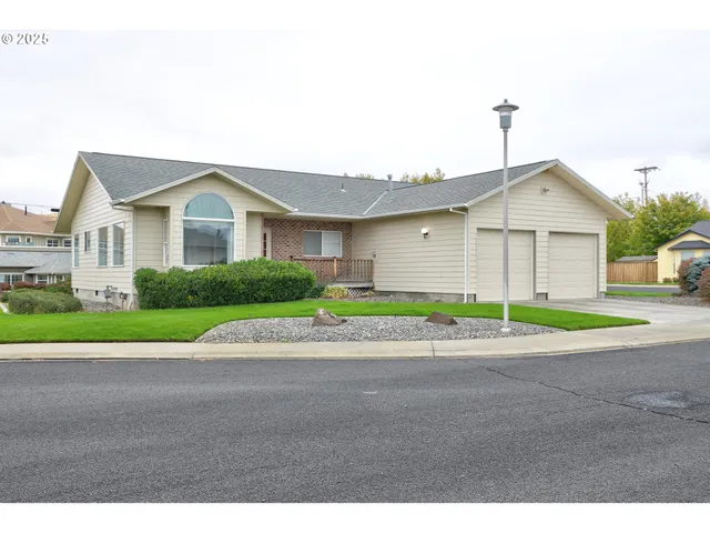 a front view of a house with a garden and garage
