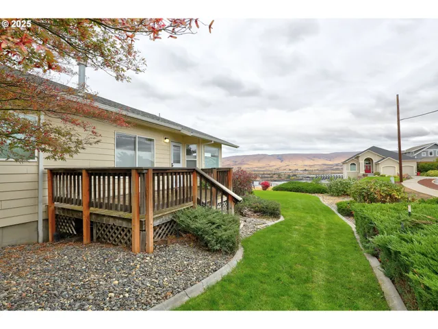 a view of a house with a backyard and deck