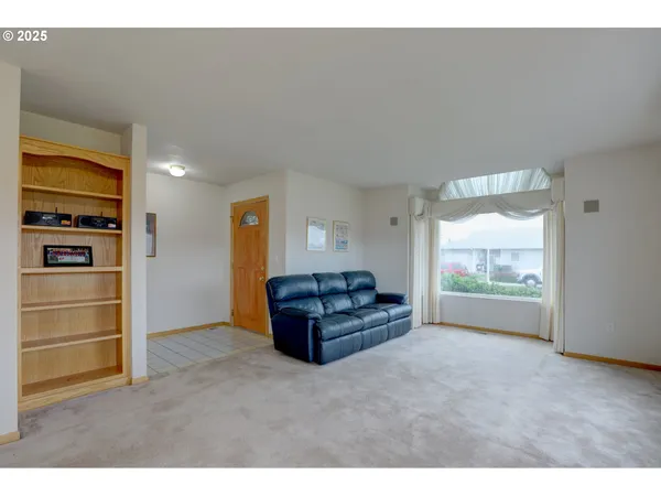 a living room with a bed and a window
